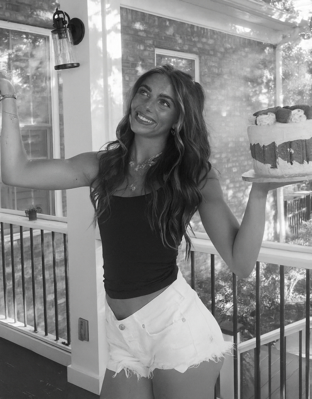 A black and white photo of a woman sitting on a couch.